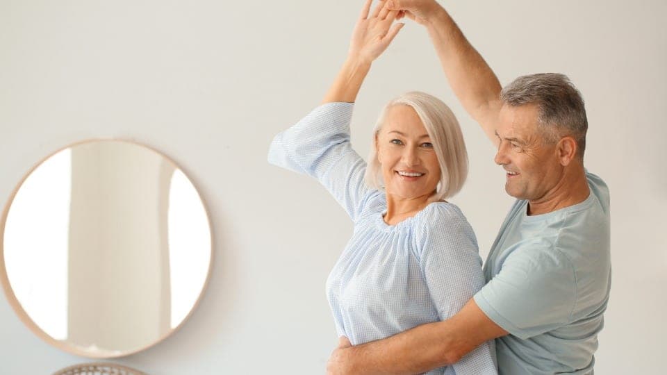 A couple dancing together at home