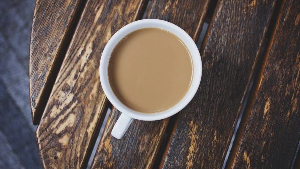A cup of coffee on a weathered wooden table